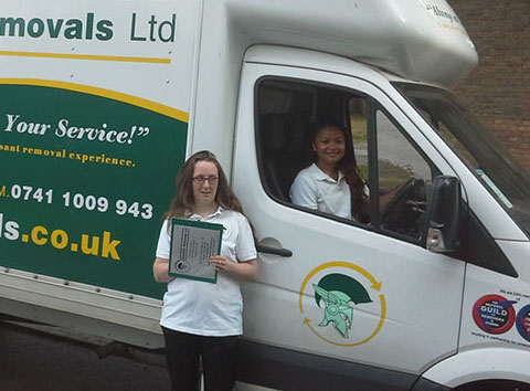 Two Gladiator Removal Quote team members, one woman in a Removal van and the other stands outside.